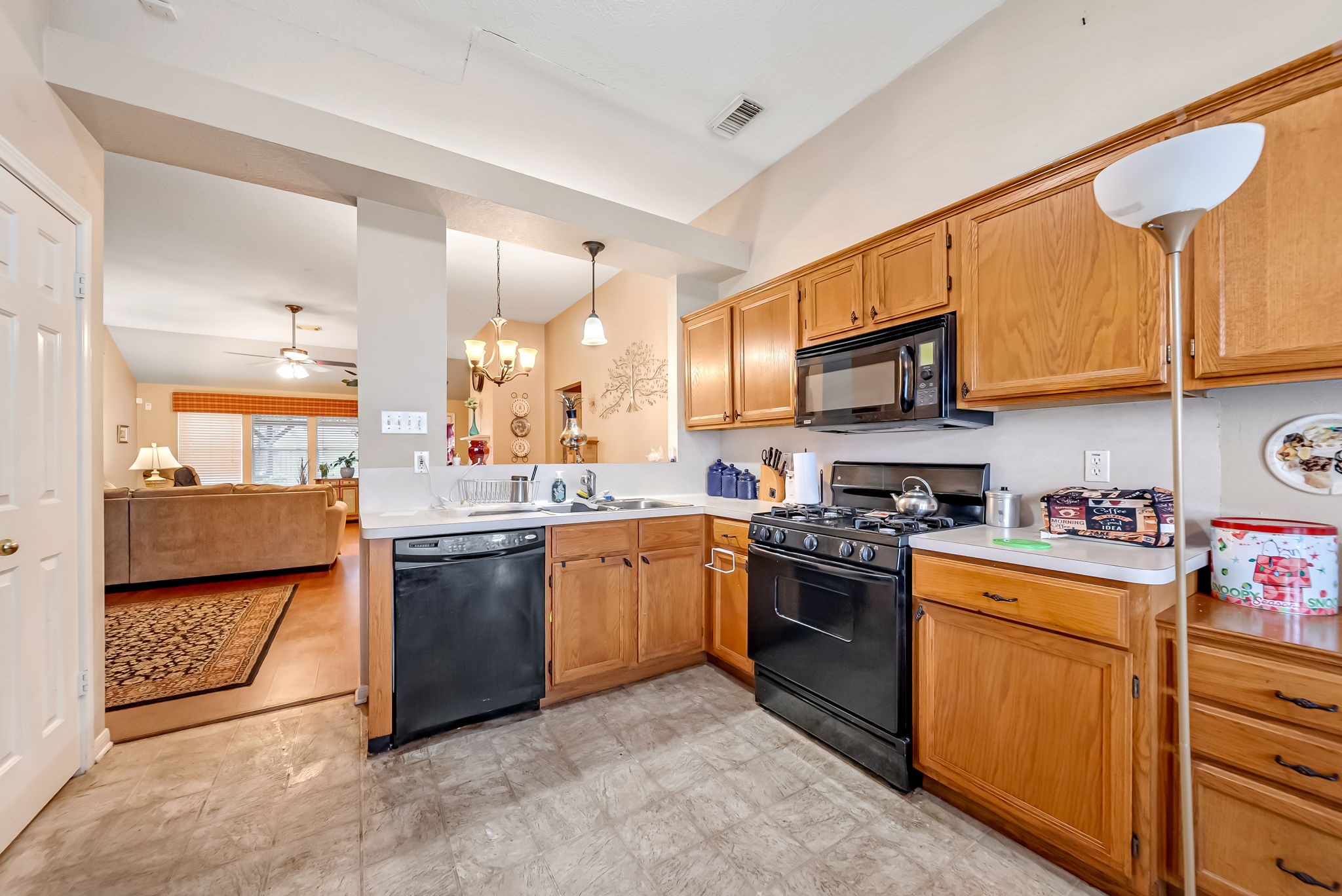 22906 Prairie Bird Lane Spring, TX 77373 - Photo 6 of 14 a kitchen with stainless steel appliances granite countertop a stove top oven a sink dishwasher and cabinets with wooden floor