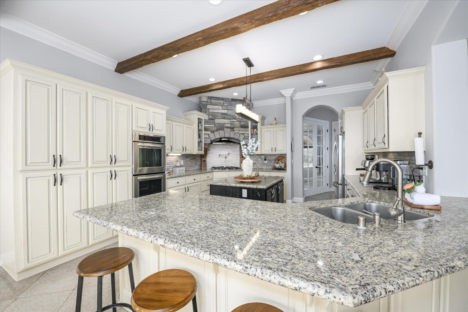 5880 Bumper Road El Dorado, CA 95623 - Photo 12 of 71 a kitchen with stainless steel appliances granite countertop a sink refrigerator and stove