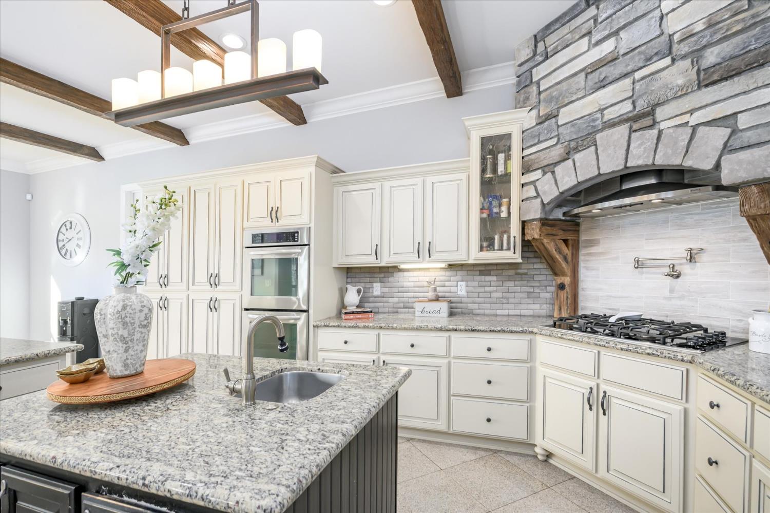 5880 Bumper Road El Dorado, CA 95623 - Photo 15 of 71 a kitchen with granite countertop a sink a stove and cabinets