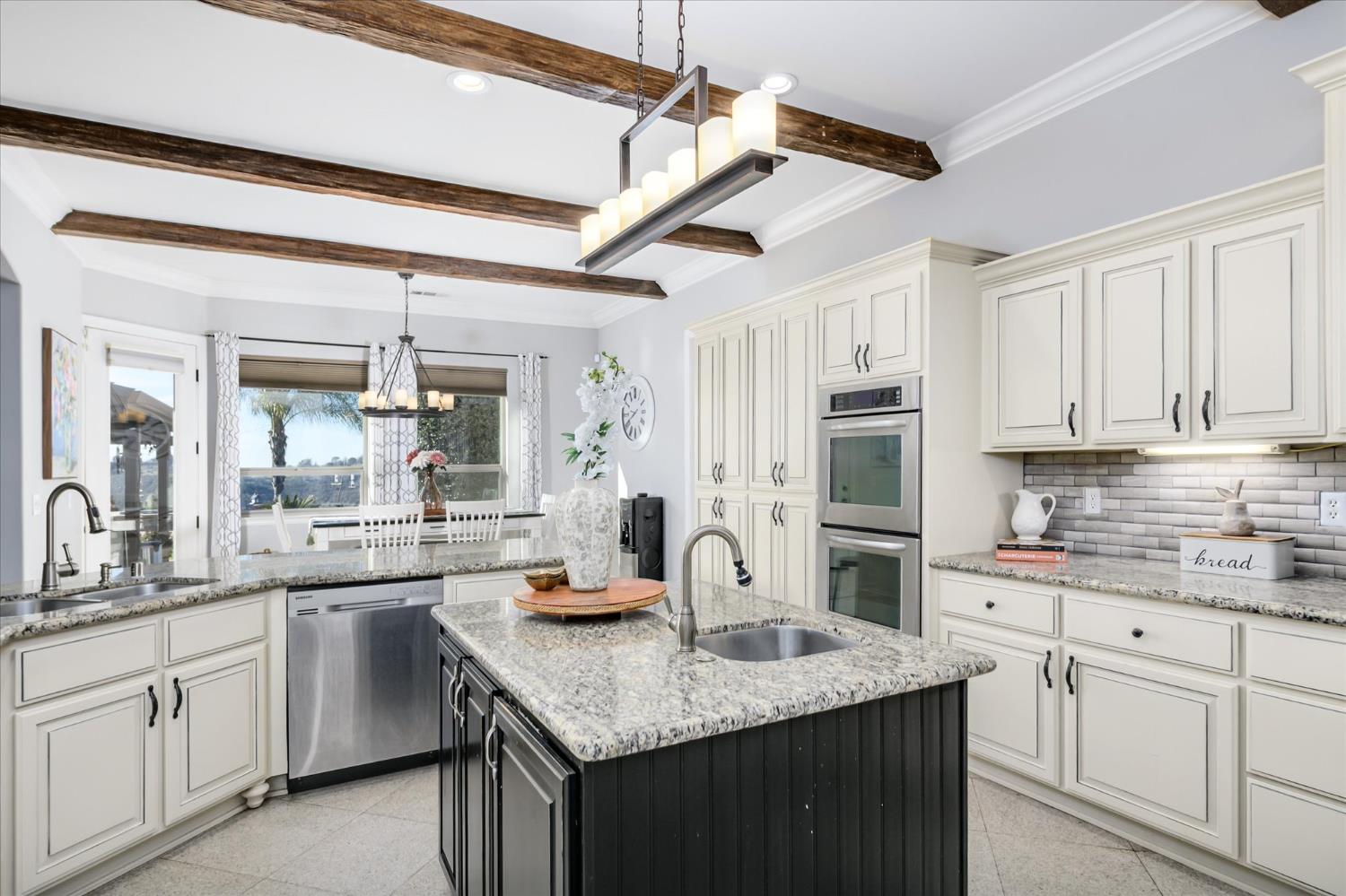 5880 Bumper Road El Dorado, CA 95623 - Photo 17 of 71 a kitchen with white cabinets sink and stainless steel appliances