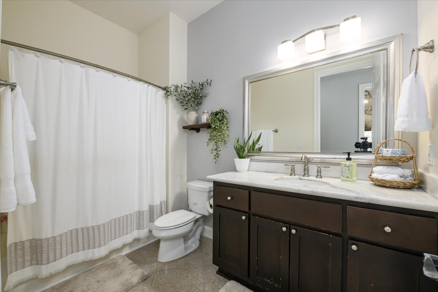 5880 Bumper Road El Dorado, CA 95623 - Photo 31 of 71 a bathroom with a double vanity sink toilet and a mirror
