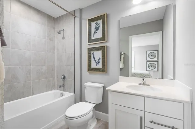 a bathroom with a toilet sink vanity and mirror
