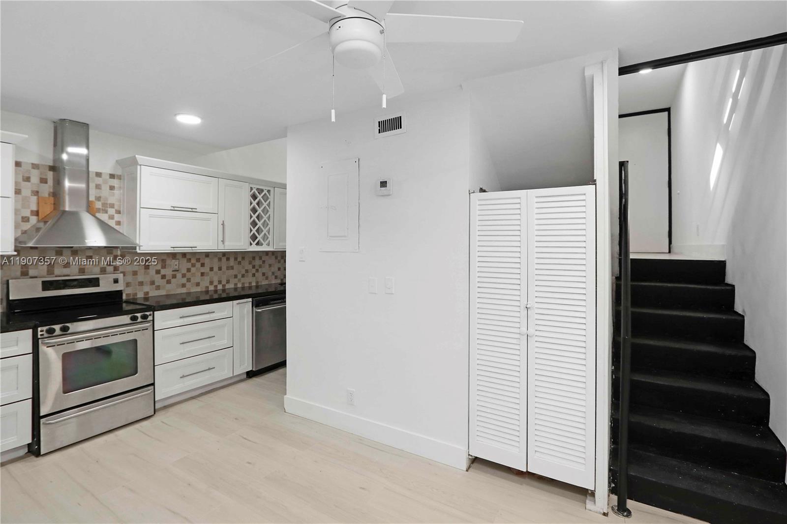 2778 Day Avenue, Unit 2 Miami, FL 33133 - Photo 10 of 21 a kitchen with granite countertop white cabinets and stainless steel appliances