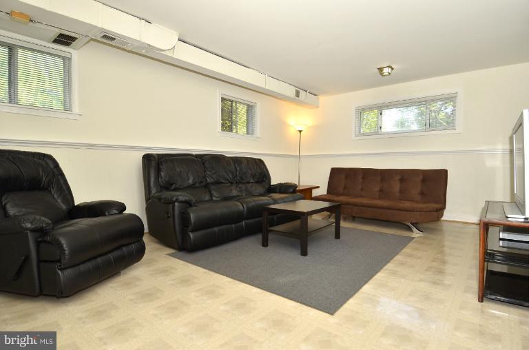 6911 Gilbert Street Springfield, VA 22150 - Photo 19 of 30 a living room with furniture a rug and a window