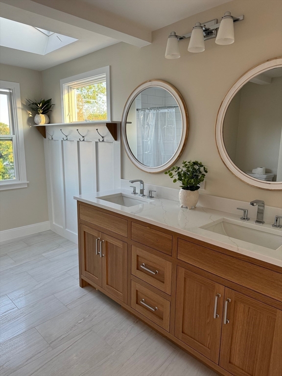 30 Gibson Street Needham, MA 02492 - Photo 14 of 17 a bathroom with a granite countertop double vanity sink and a mirror