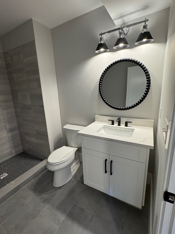 30 Gibson Street Needham, MA 02492 - Photo 16 of 17 a bathroom with a sink mirror vanity and toilet