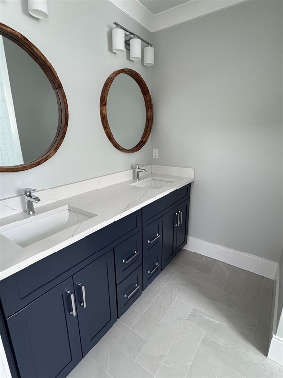 30 Gibson Street Needham, MA 02492 - Photo 17 of 17 a bathroom with a double vanity sink and a mirror