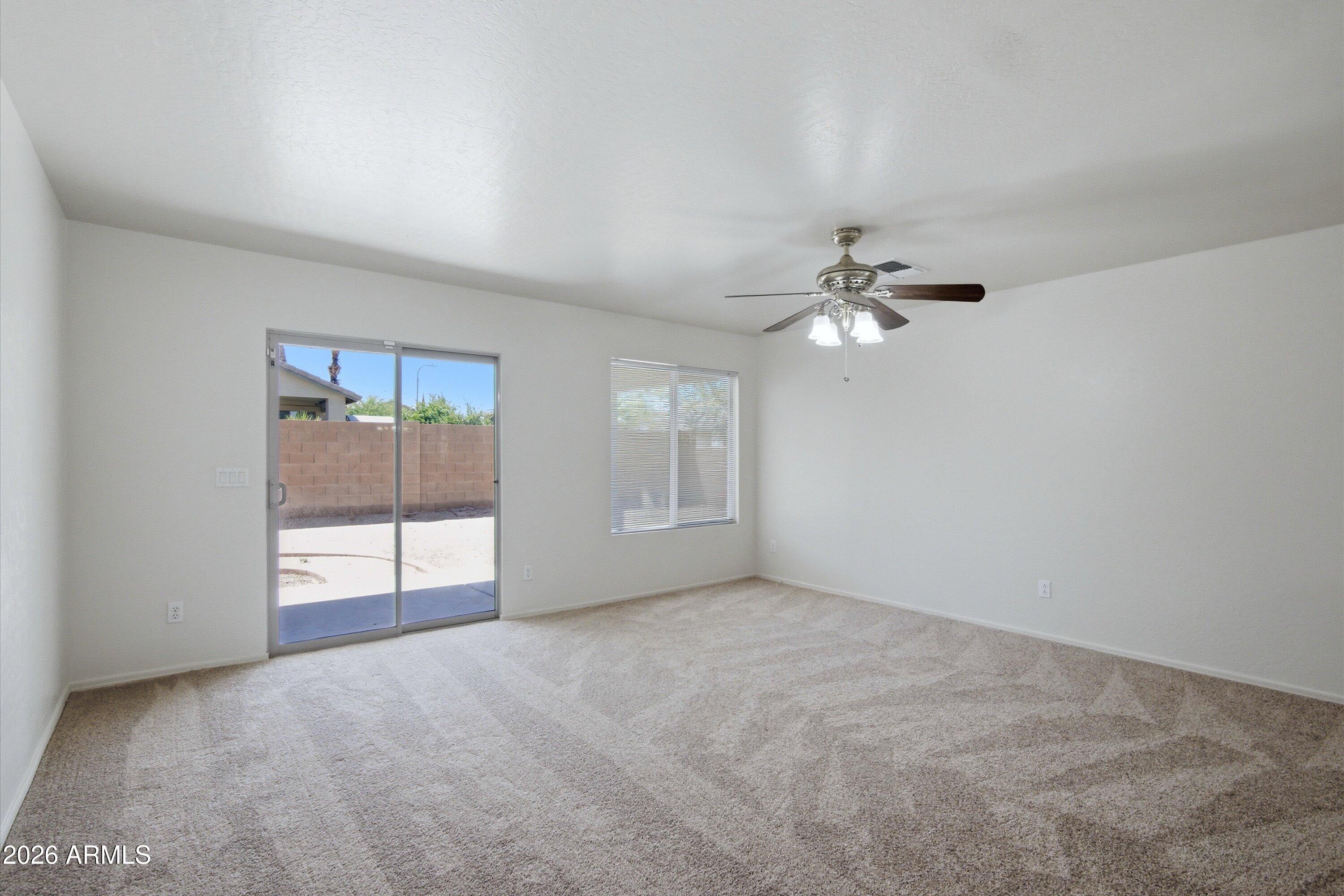 2933 West Maldonado Road Phoenix, AZ 85041 - Photo 16 of 27 a view of a livingroom with a ceiling fan and window