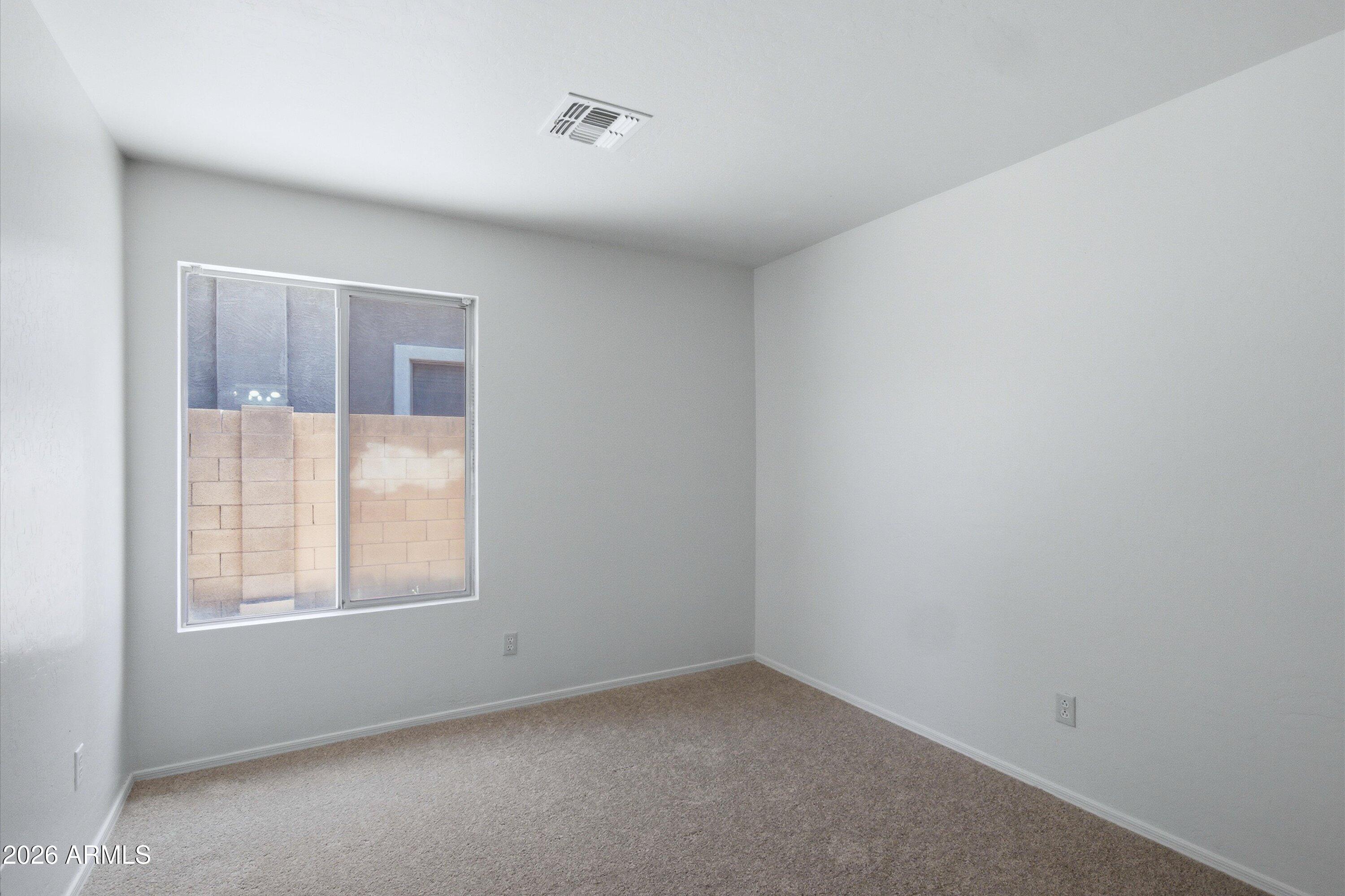 2933 West Maldonado Road Phoenix, AZ 85041 - Photo 20 of 27 an empty room with a window