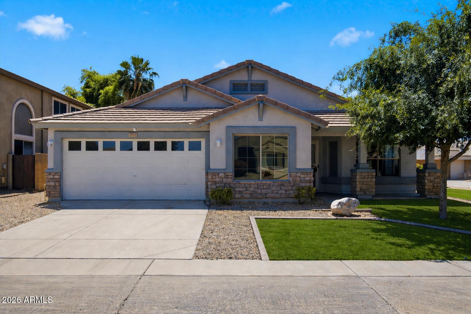2933 West Maldonado Road Phoenix, AZ 85041 - Photo 2 of 27 a front view of a house with garden