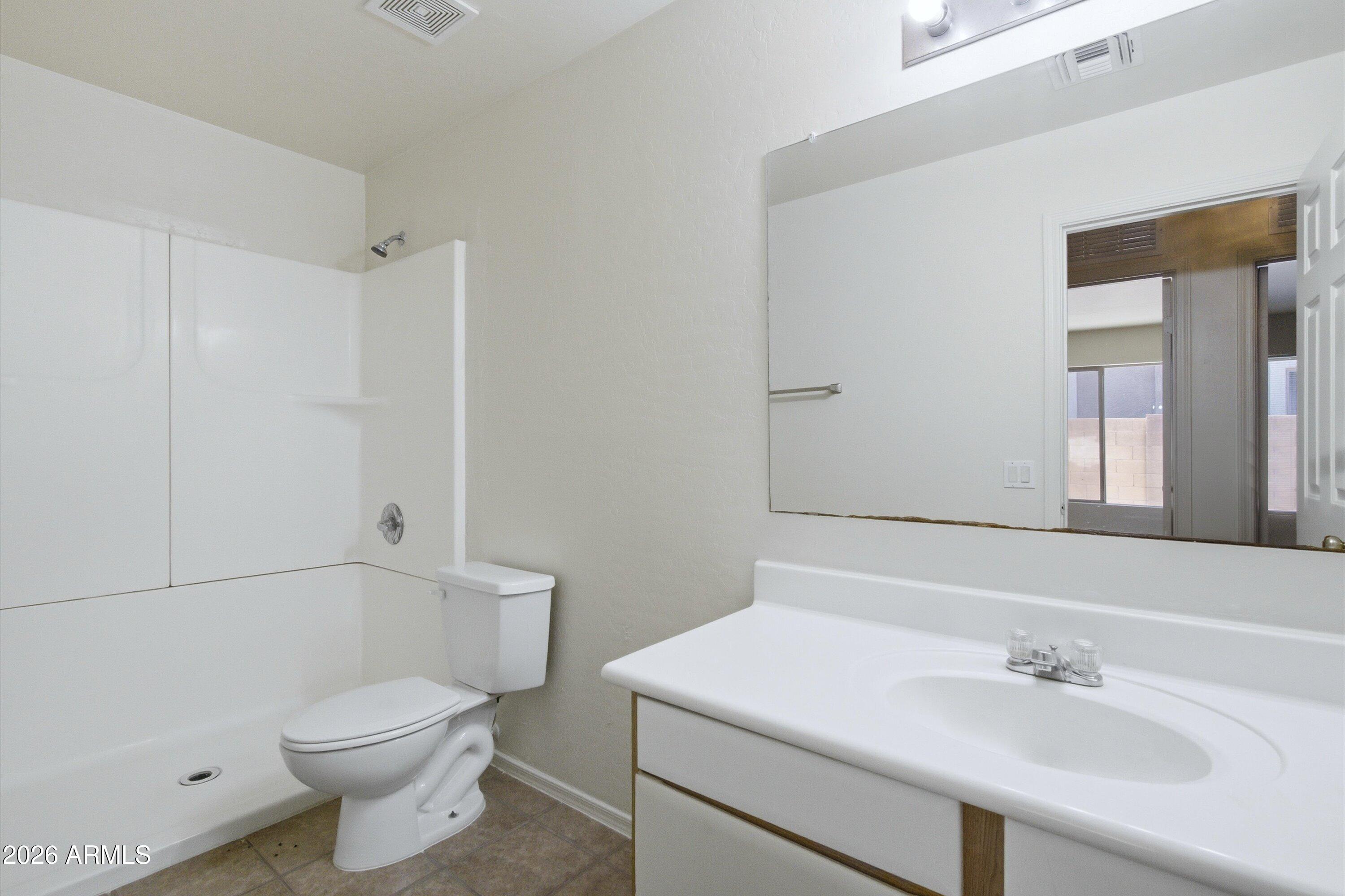 2933 West Maldonado Road Phoenix, AZ 85041 - Photo 23 of 27 a bathroom with a sink a toilet and shower