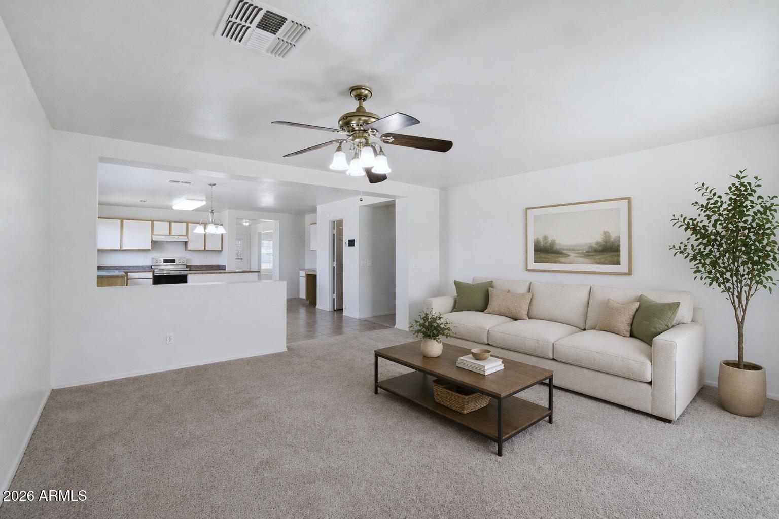 2933 West Maldonado Road Phoenix, AZ 85041 - Photo 4 of 27 a living room with furniture and a chandelier