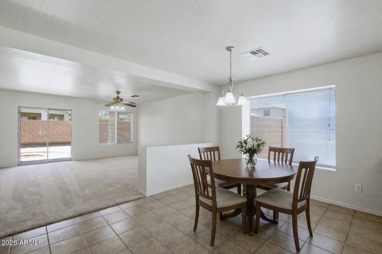 2933 West Maldonado Road Phoenix, AZ 85041 - Photo 5 of 27 a view of a dining room with furniture and chandelier