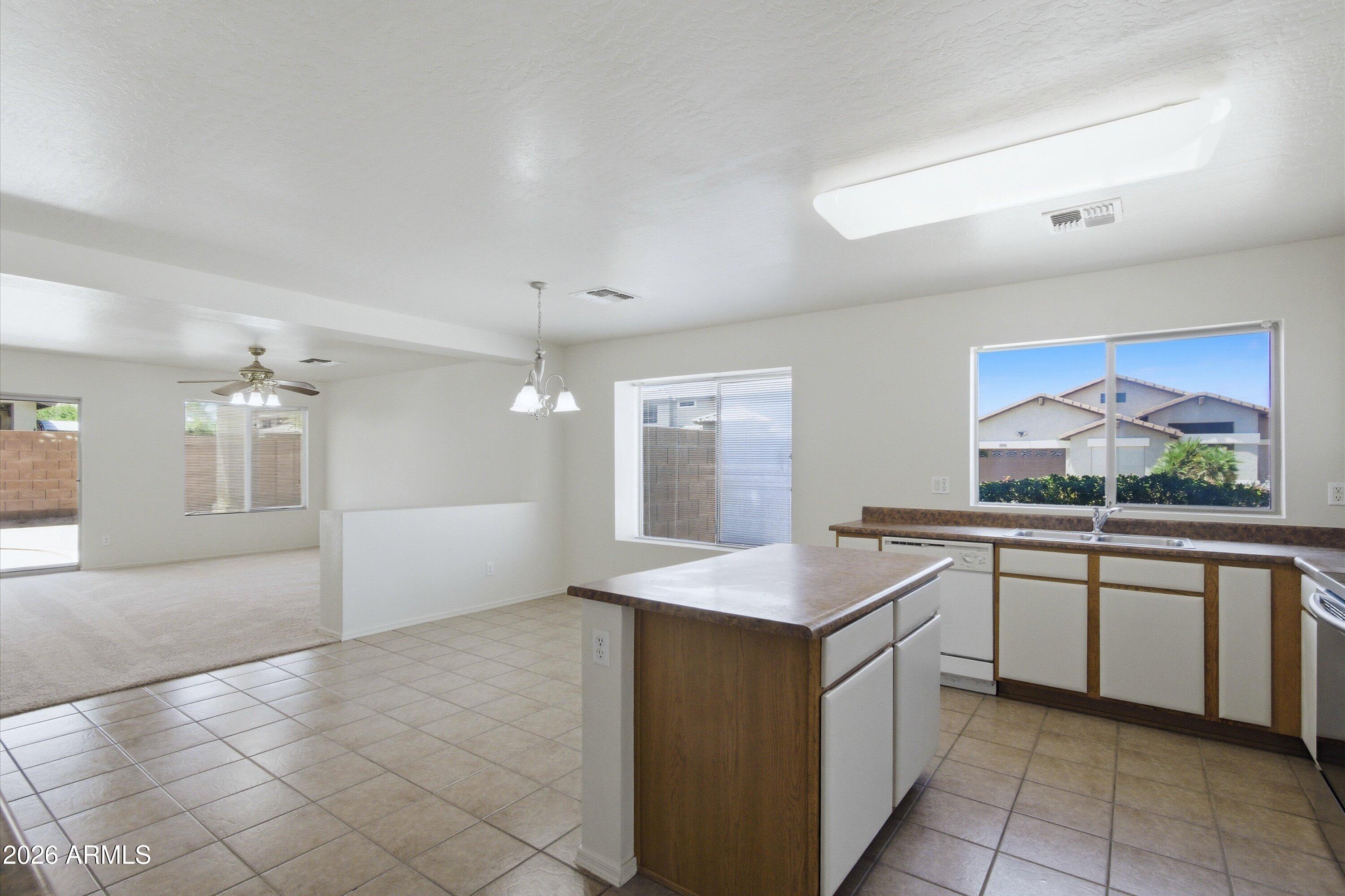 2933 West Maldonado Road Phoenix, AZ 85041 - Photo 9 of 27 a kitchen with a sink and cabinets
