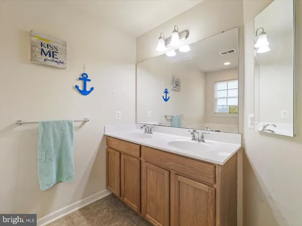 a bathroom with a sink mirror and vanity