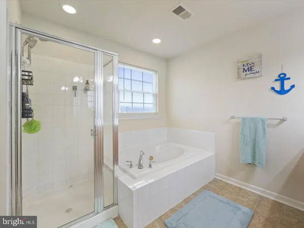 a white bath tub sitting next to a shower