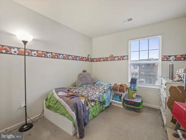 a bedroom with a bed a desk and chair