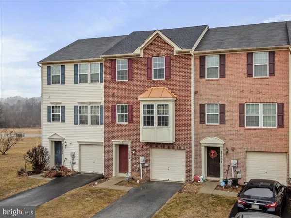 a front view of a house with parking space