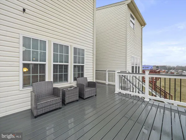 a balcony with furniture and wooden floor