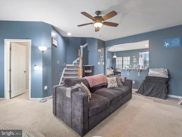 a living room with furniture and a large mirror
