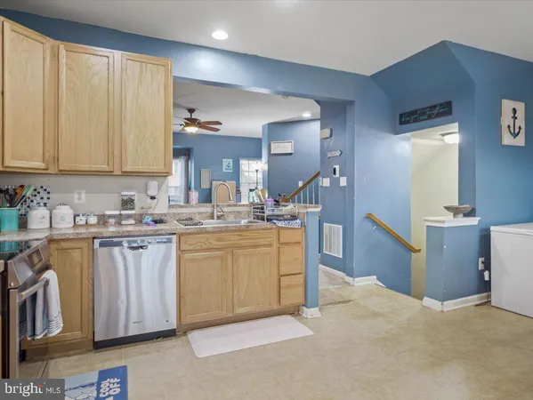 a kitchen with sink and cabinets