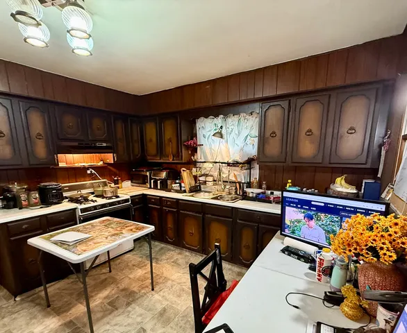 a kitchen with a sink appliances and cabinets
