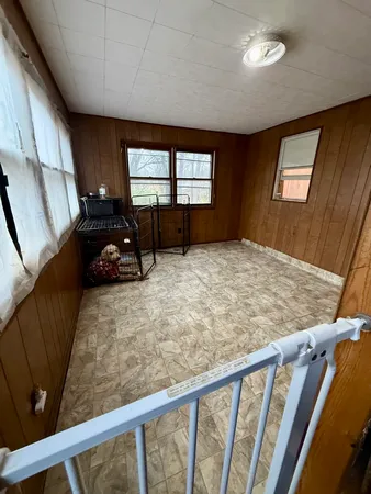 a bed sitting in a bedroom next to a window