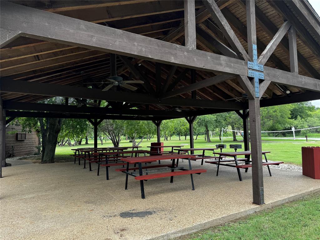 4044 High Point Drive Whitney, TX 76692 - Photo 13 of 14 a view of a patio with table and chairs under a large umbrella