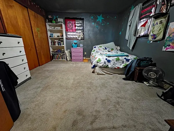 a bedroom with furniture and a baby crib