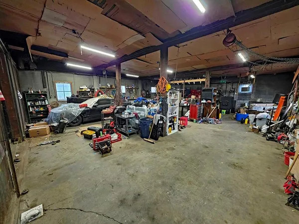 a view of a garage with a bike and car