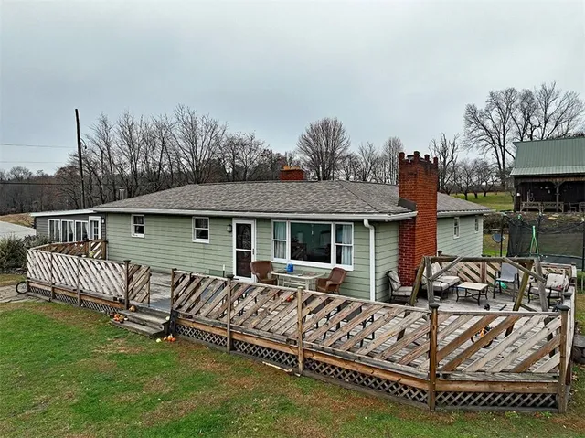 a view of a house with a yard and sitting area