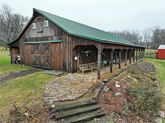 a wooden bench sitting in front of a house