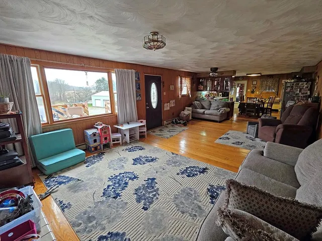 a living room with furniture large window and a table