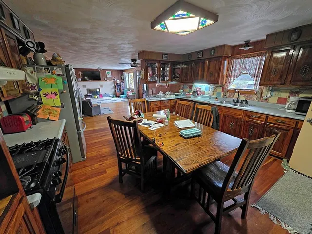 a view of a dining room with furniture and a kitchen