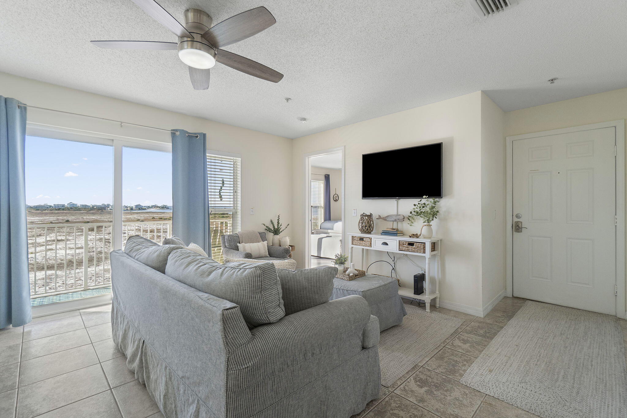 8436 Gulf Boulevard, Unit 321 Navarre, FL 32566 - Photo 16 of 57 a living room with furniture and a flat screen tv