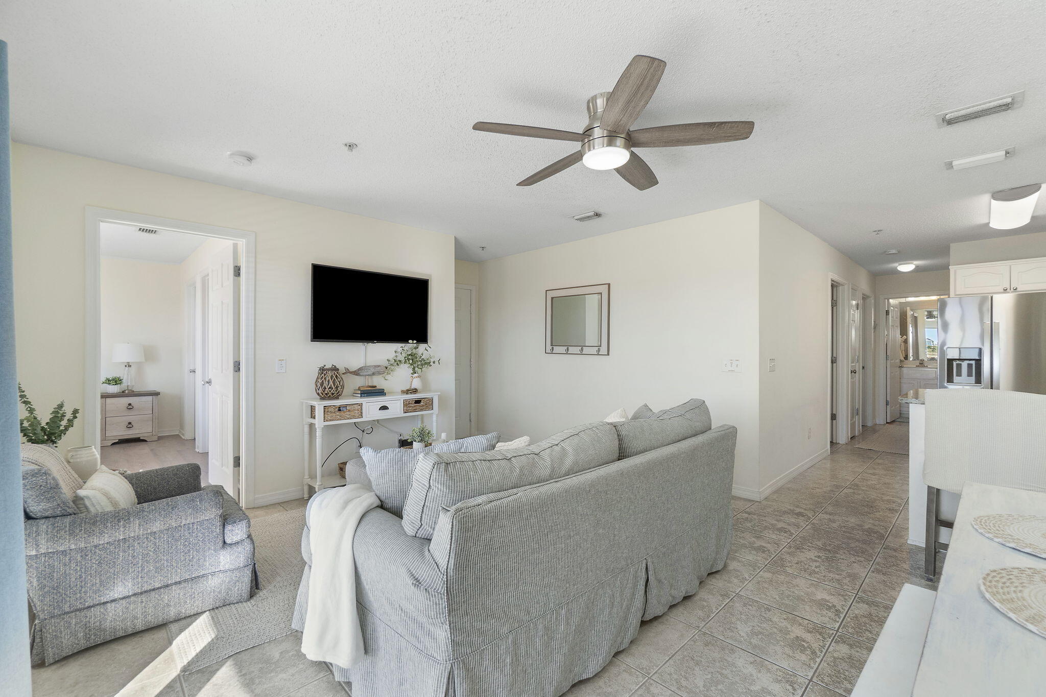 8436 Gulf Boulevard, Unit 321 Navarre, FL 32566 - Photo 17 of 57 a living room with furniture and a flat screen tv