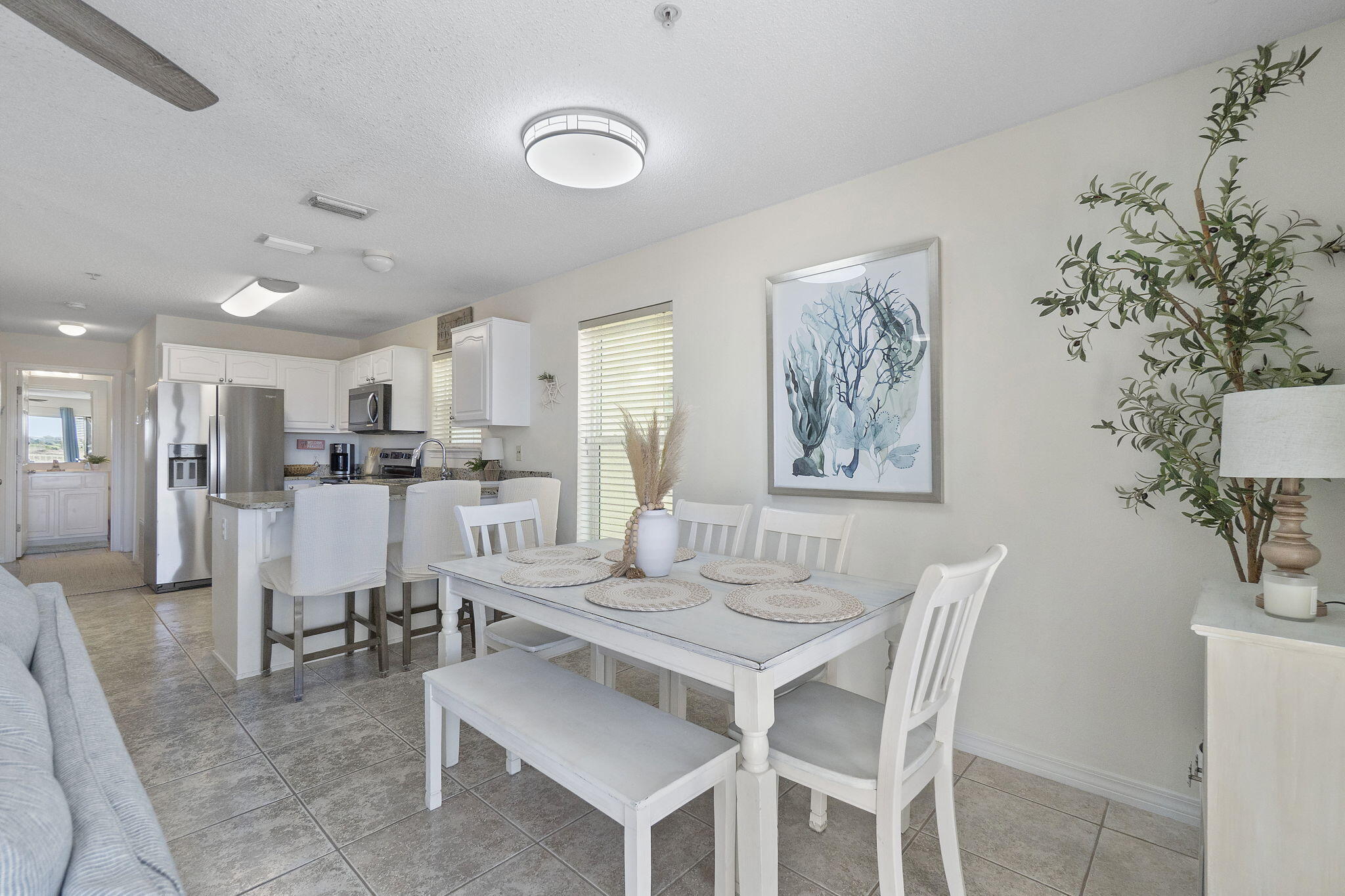 8436 Gulf Boulevard, Unit 321 Navarre, FL 32566 - Photo 23 of 57 a view of a dining room with furniture and wooden floor