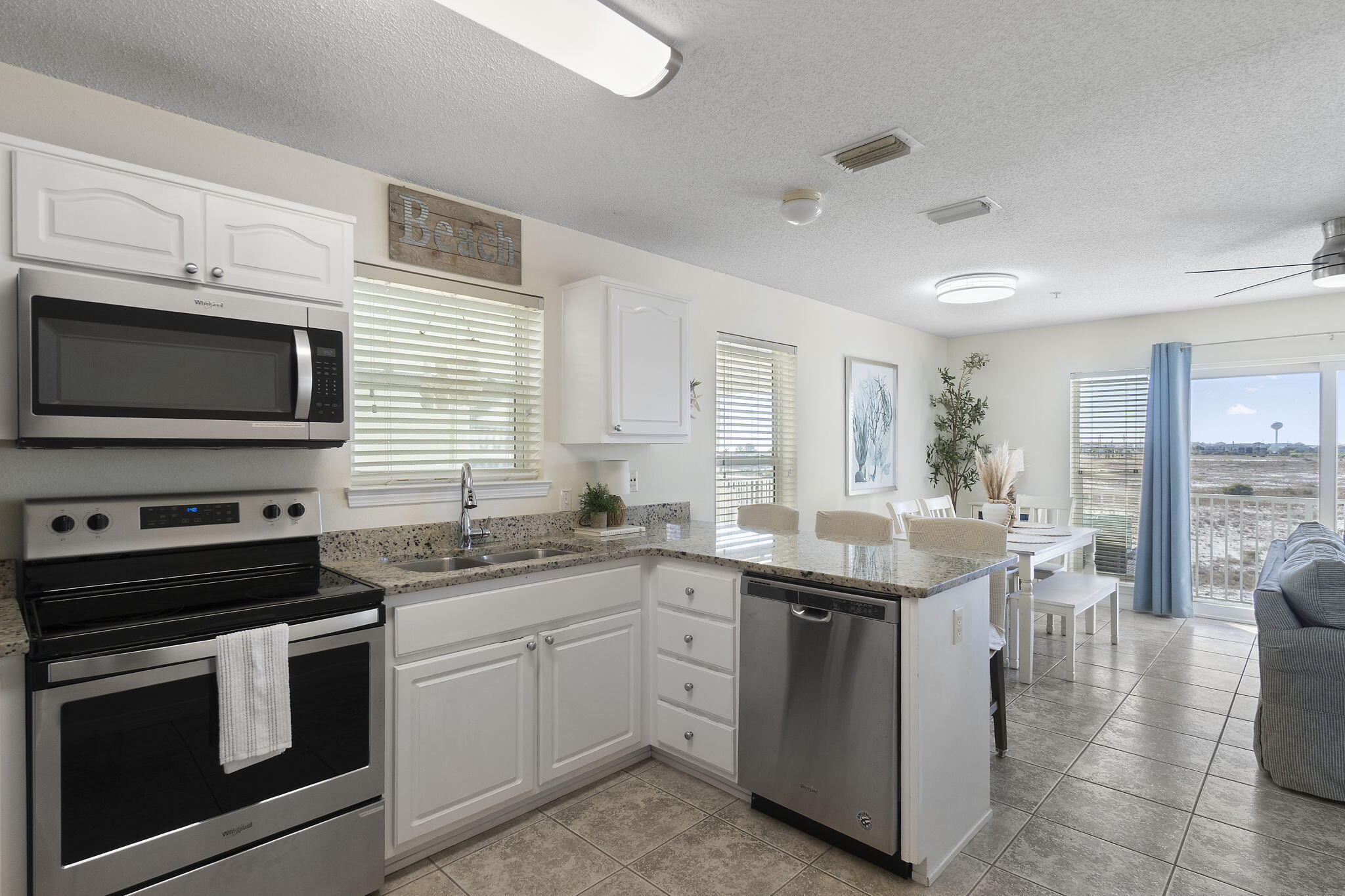 8436 Gulf Boulevard, Unit 321 Navarre, FL 32566 - Photo 27 of 57 a kitchen with a sink stove and microwave
