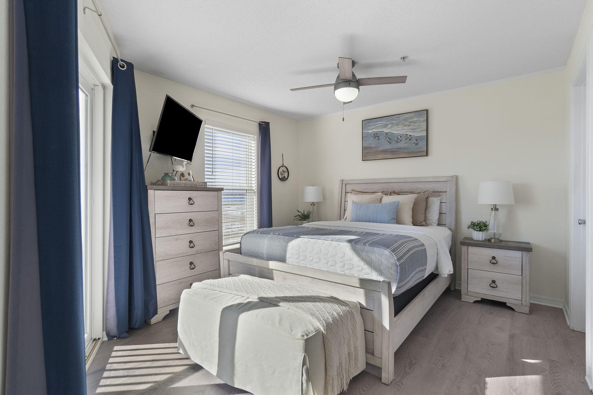 8436 Gulf Boulevard, Unit 321 Navarre, FL 32566 - Photo 28 of 57 a bedroom with a bed and a flat screen tv