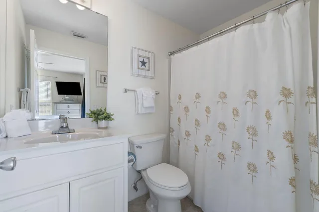 a bathroom with a toilet a sink and a mirror