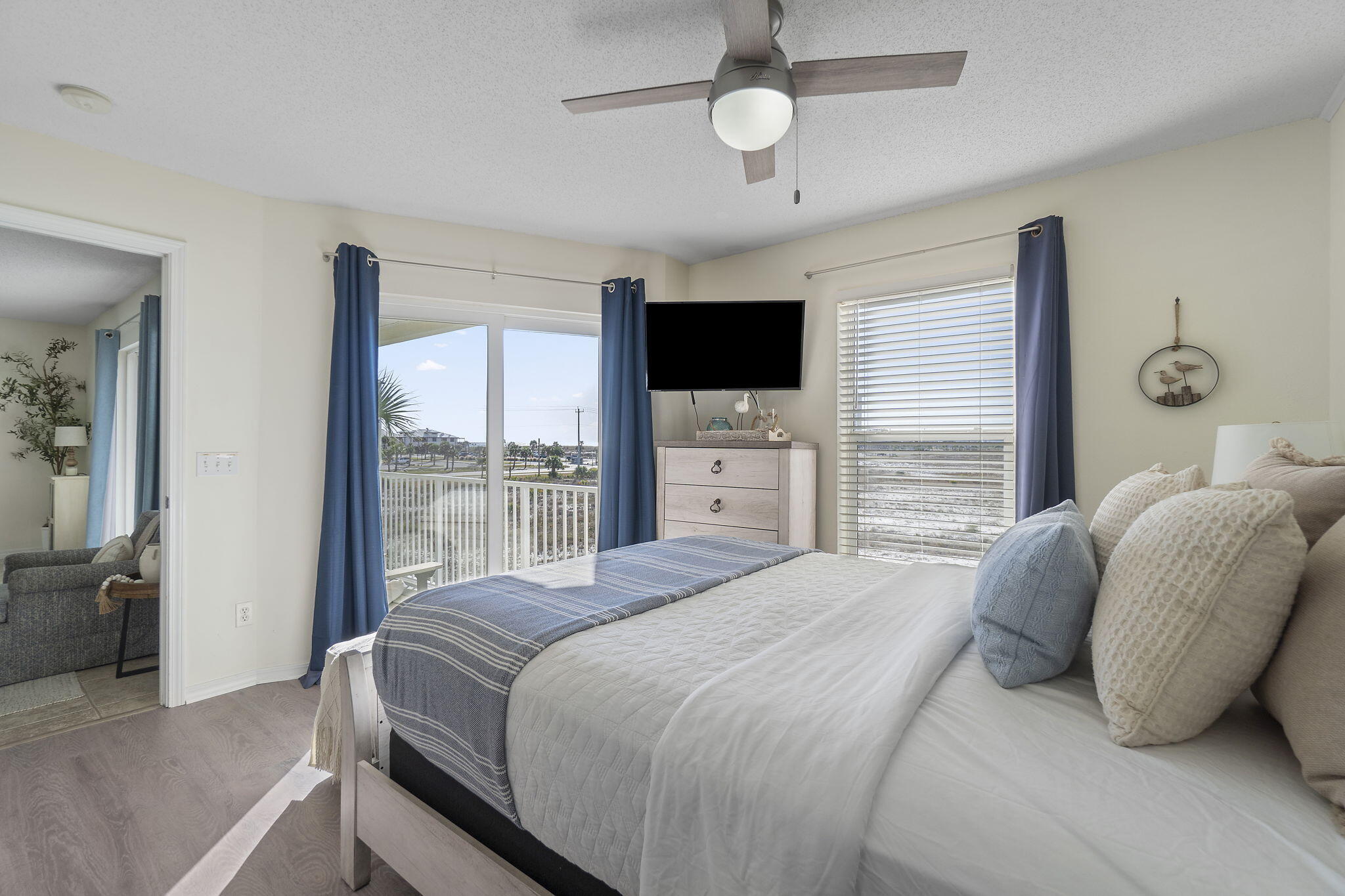 8436 Gulf Boulevard, Unit 321 Navarre, FL 32566 - Photo 30 of 57 a bedroom with a large bed and a flat screen tv