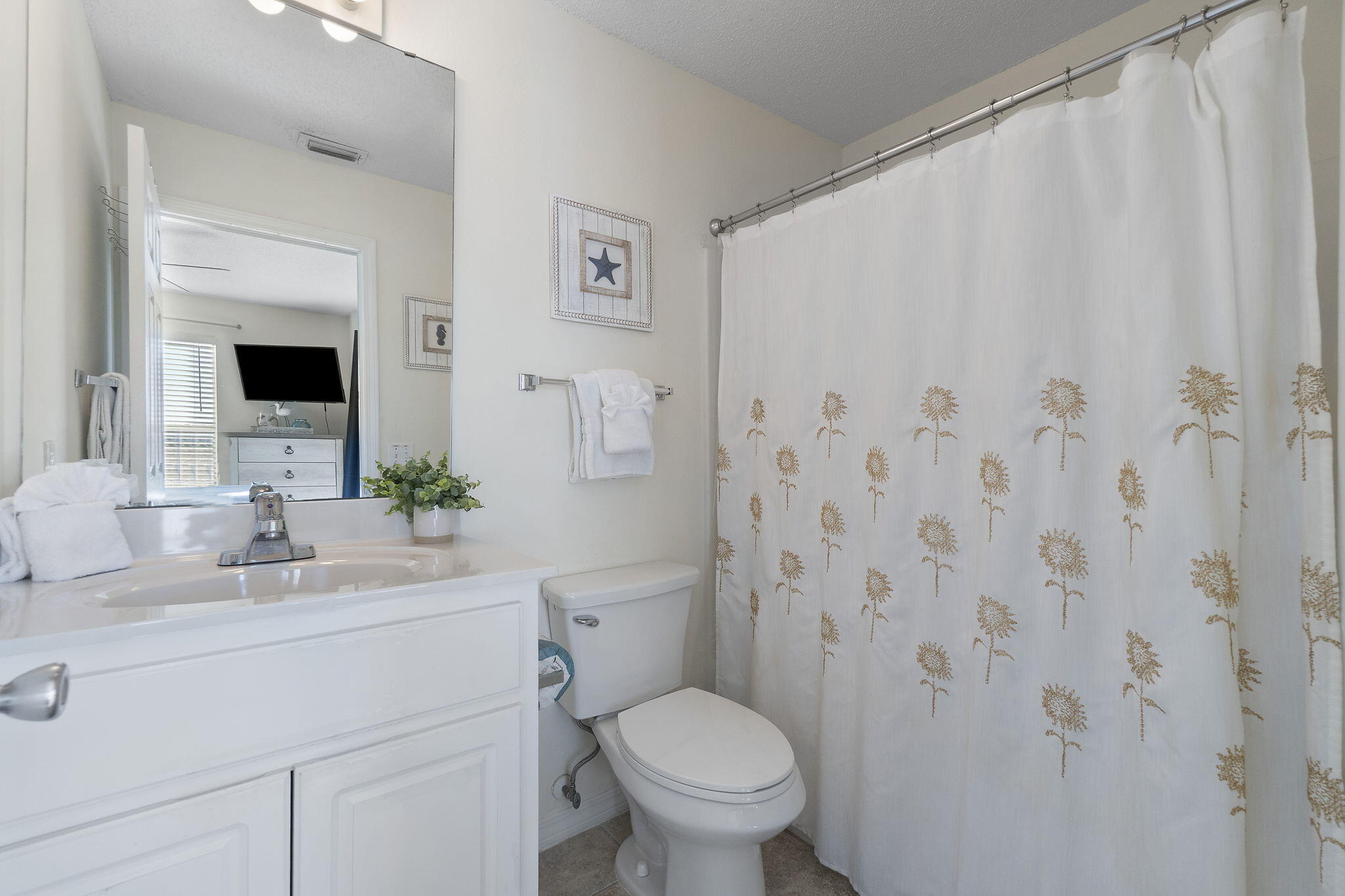 8436 Gulf Boulevard, Unit 321 Navarre, FL 32566 - Photo 32 of 57 a bathroom with a toilet sink and mirror