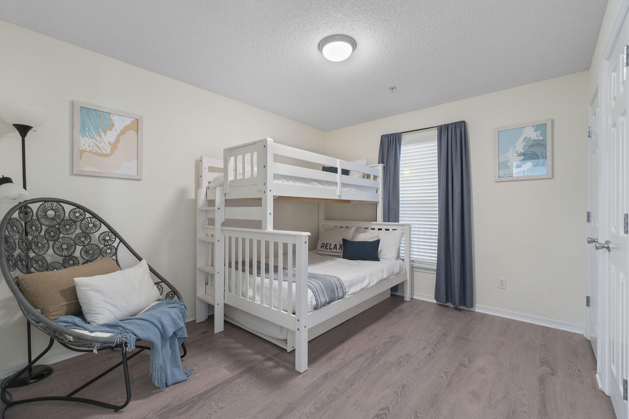 8436 Gulf Boulevard, Unit 321 Navarre, FL 32566 - Photo 33 of 57 a view of a bedroom with furniture and wooden floor