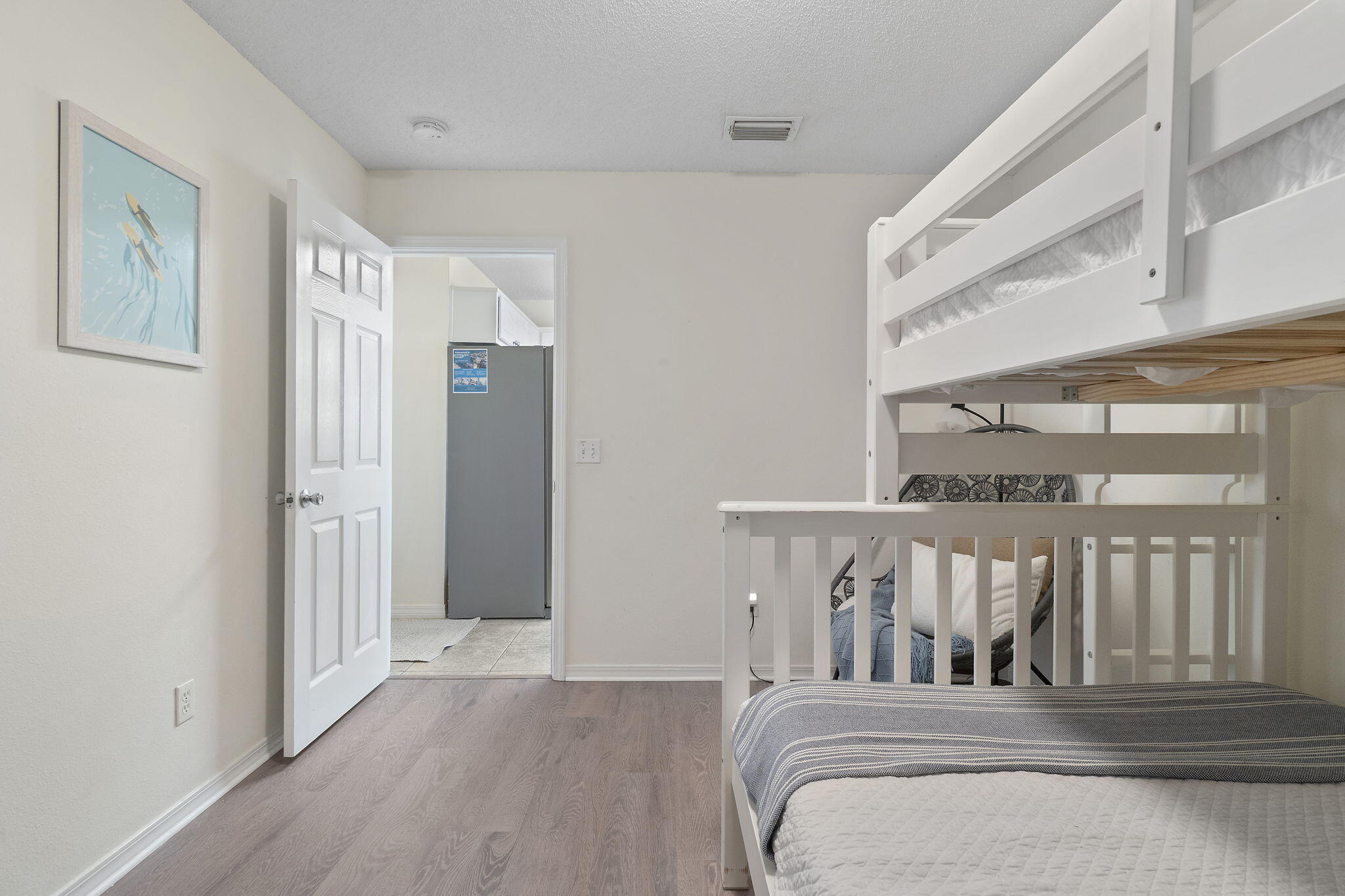 8436 Gulf Boulevard, Unit 321 Navarre, FL 32566 - Photo 34 of 57 a bedroom with a bed with wooden floor
