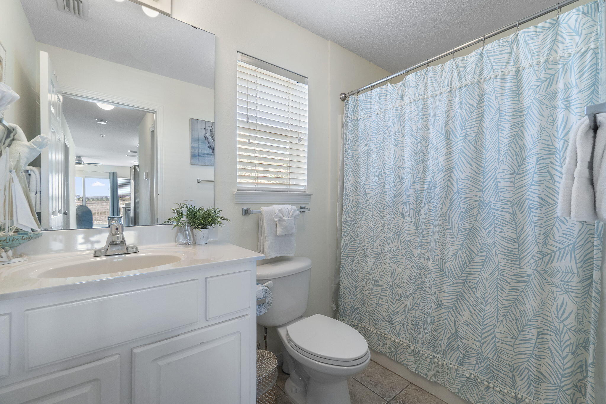8436 Gulf Boulevard, Unit 321 Navarre, FL 32566 - Photo 36 of 57 a bathroom with a toilet a sink and a mirror