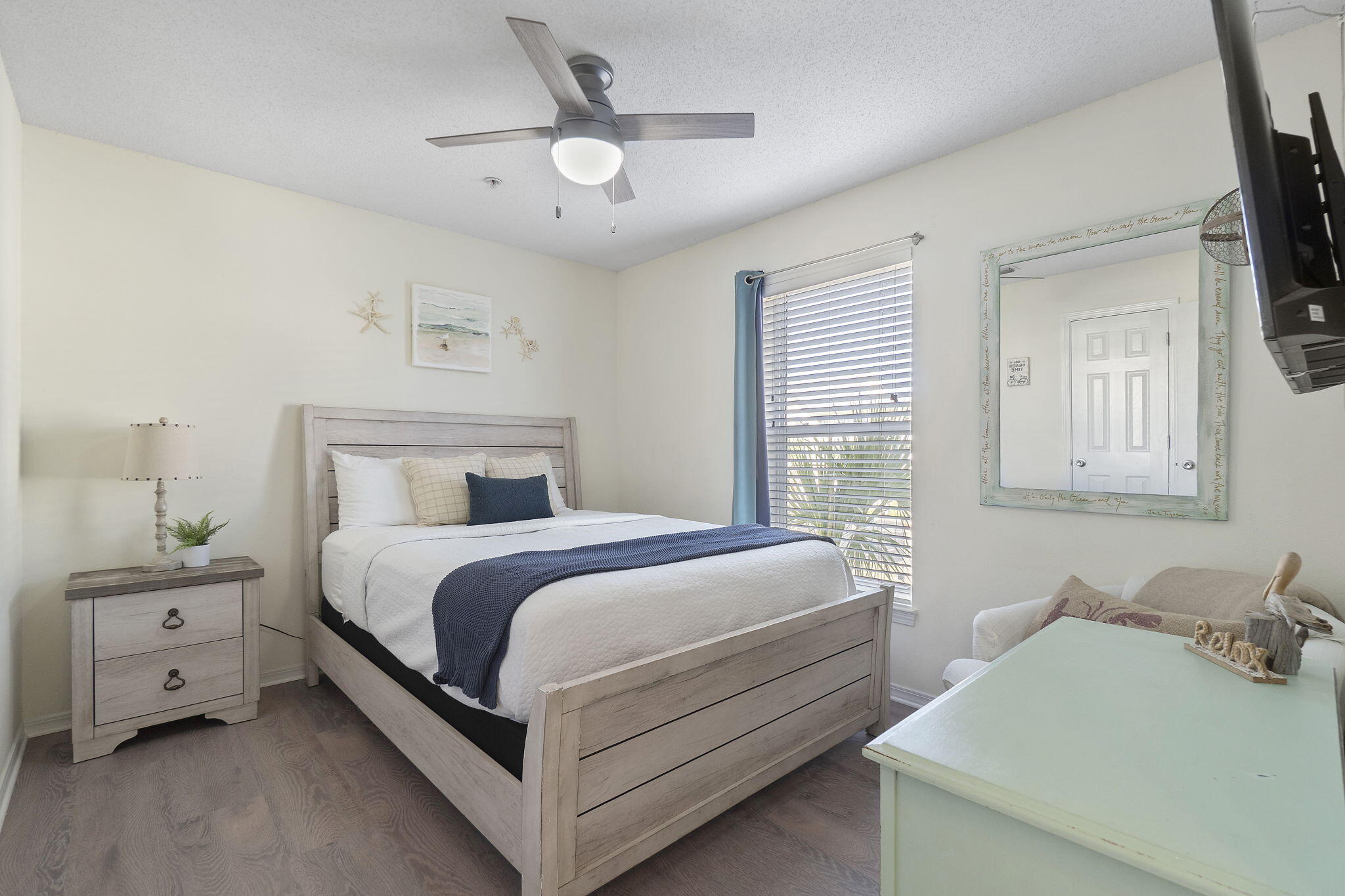 8436 Gulf Boulevard, Unit 321 Navarre, FL 32566 - Photo 37 of 57 a bedroom with a bed and a chandelier