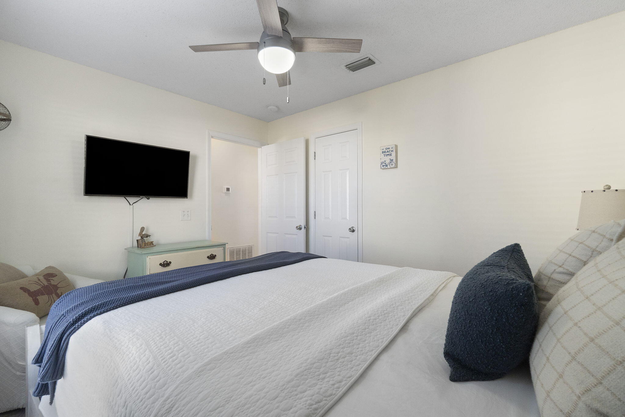 8436 Gulf Boulevard, Unit 321 Navarre, FL 32566 - Photo 38 of 57 a bedroom with a bed and a flat screen tv