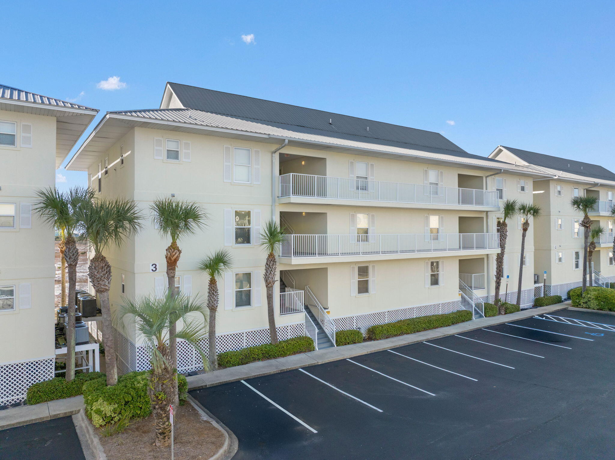 8436 Gulf Boulevard, Unit 321 Navarre, FL 32566 - Photo 47 of 57 a front view of a building with a garden and plants