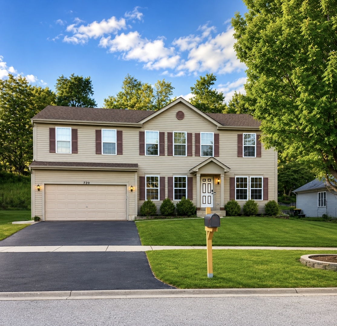 720 Ridge Drive Marengo, IL 60152 - Photo 1 of 34 a front view of a house with a garden and plants