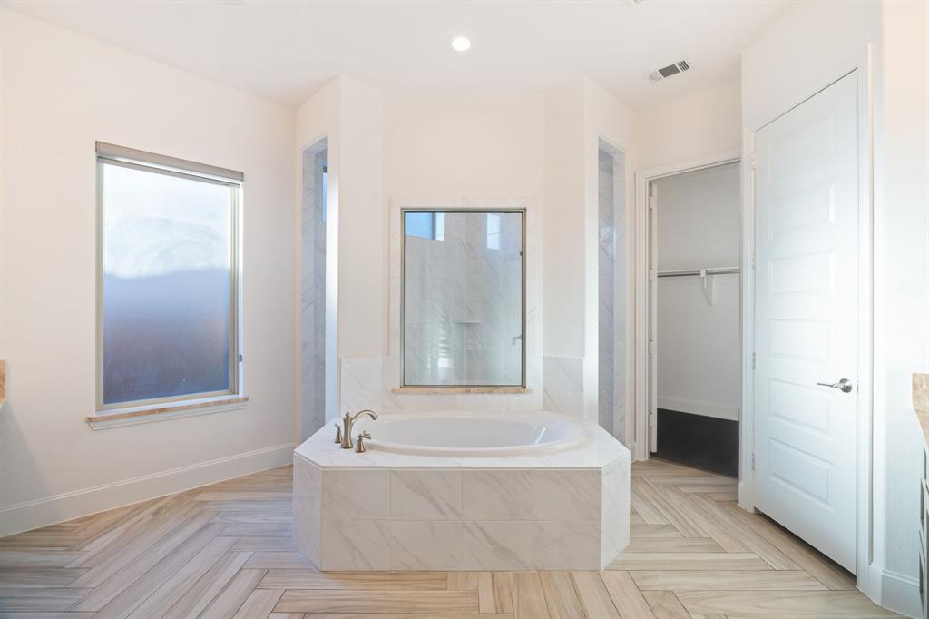 2441 Flat Creek Road Frisco, TX 75036 - Photo 17 of 34 Bathroom featuring a walk in closet, a garden tub, and recessed lighting